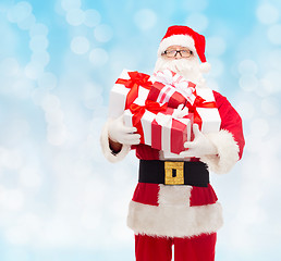 Image showing man in costume of santa claus with gift boxes