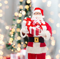 Image showing man in costume of santa claus with gift boxes