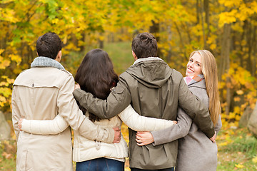 Image showing group of smiling men and women in autumn park