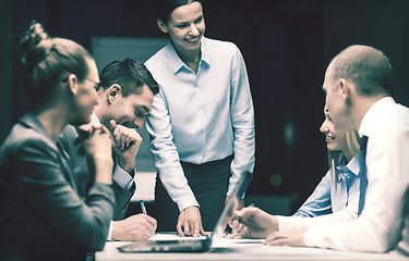 Image showing smiling female boss talking to business team