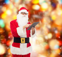 Image showing man in costume of santa claus with tablet pc