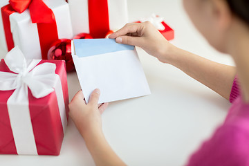 Image showing close up of woman with letter and presents