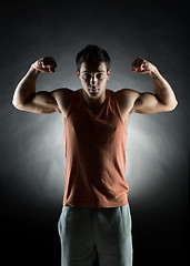 Image showing young man showing biceps