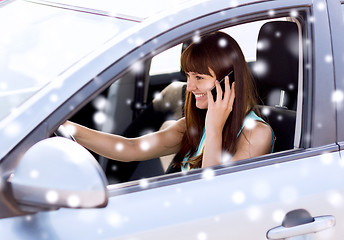 Image showing close up of woman with smartphone driving car