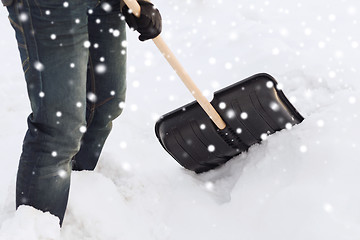 Image showing closeup of man digging snow with shovel