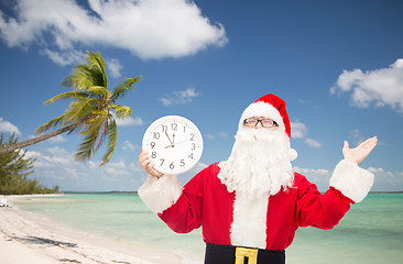 Image showing man in costume of santa claus with clock