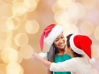 Image showing happy mother and girl in santa hats