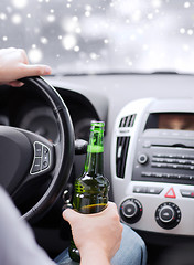 Image showing close up of man drinking alcohol while driving car