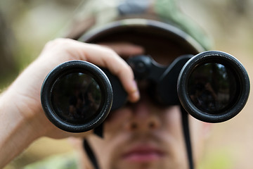 Image showing close up of soldier or hunter with binocular