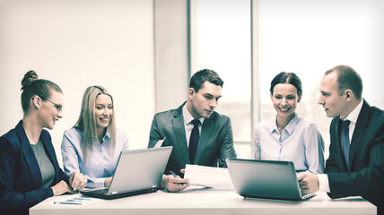 Image showing business team with laptop having discussion
