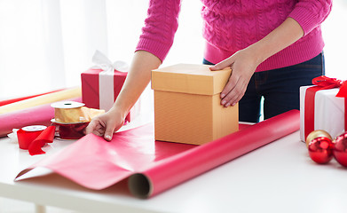 Image showing close up of woman decorating christmas presents