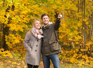 Image showing smiling couple hugging in autumn park