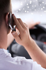 Image showing close up of man using smartphone while driving car