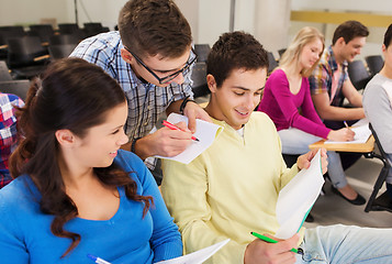 Image showing group of smiling students in lecture hall