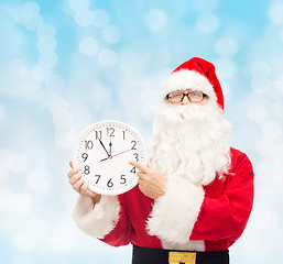 Image showing man in costume of santa claus with clock