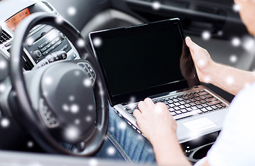 Image showing close up of man using laptop in car