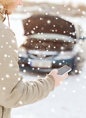 Image showing closeup of man with broken car and smartphone