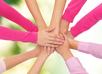 Image showing close up of women with hands on top