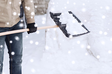 Image showing closeup of man digging snow with shovel near car