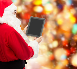 Image showing man in costume of santa claus with tablet pc