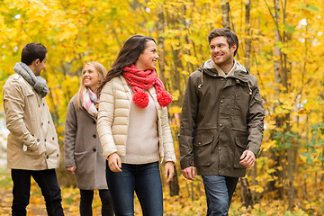 Image showing group of smiling men and women in autumn park