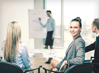 Image showing businesswoman with team showing in office