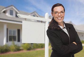 Image showing Woman In Front Of House and Blank Real Estate Sign