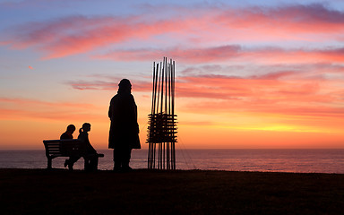 Image showing Two sculptures two spectators, sunrise Sculpture by the Sea