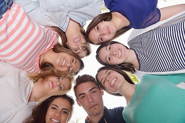 Image showing young friends staying together outdoor in the park