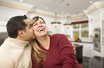 Image showing Mixed Race Couple Kissing Inside Beautiful Custom Kitchen