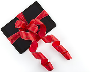 Image showing tablet pc with christmas red ribbon