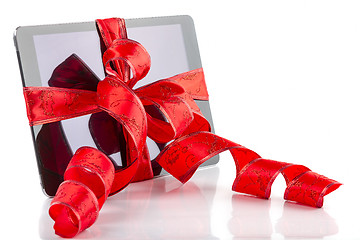 Image showing tablet pc with christmas red ribbon