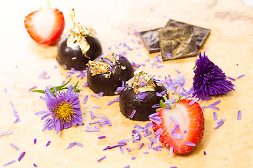 Image showing dark chocolate on a wooden table.