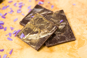 Image showing dark chocolate on a wooden table.