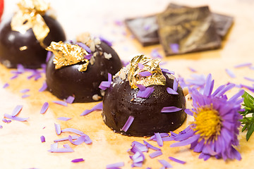 Image showing dark chocolate on a wooden table.