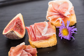 Image showing Slices of figs in Prosciutto