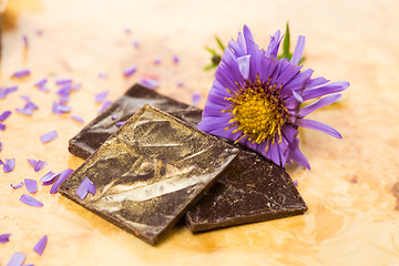 Image showing dark chocolate on a wooden table.