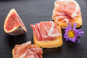 Image showing Slices of figs in Prosciutto