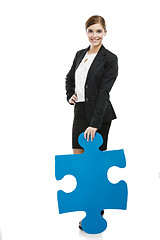 Image showing Businesswoman with a puzzle piece