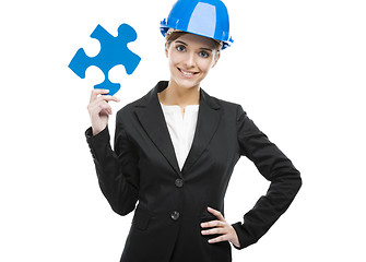 Image showing Female engineer with a puzzle piece