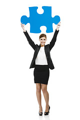 Image showing Businesswoman with a puzzle piece