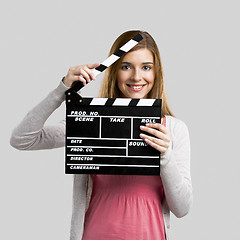 Image showing Beautiful girl holding clapboard