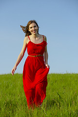 Image showing Beautiful girl walking with a red dress