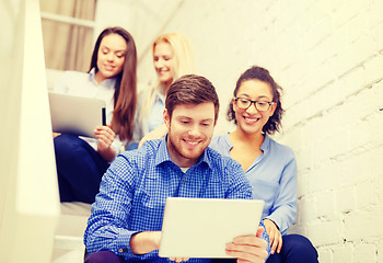 Image showing team with tablet pc computer sitting on staircase