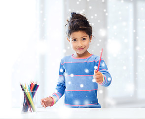 Image showing smiling little girl with pencils drawing at home