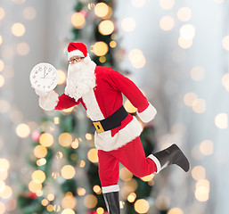 Image showing man in costume of santa claus with clock