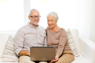 Image showing happy senior couple with laptop at home