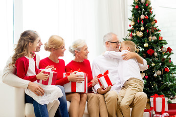 Image showing smiling family with gifts at home