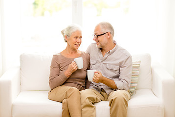 Image showing happy senior couple with cups at home