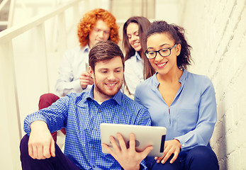 Image showing team with tablet pc computer sitting on staircase